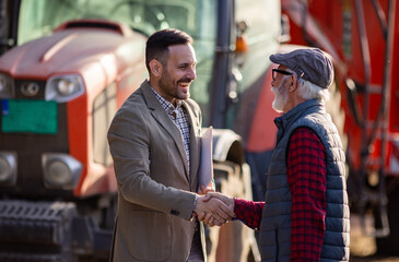 Bank agent and farmer shaking hands on farm © Budimir Jevtic
