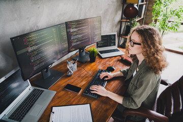 Photo of lovely confident successful woman software developer touch keyboard comfortable workspace...