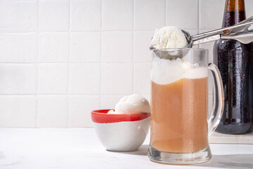 Ice cream beer floating cocktail, summer cold refreshment alcoholic drink, Root beer float in pint mug glass, copy space