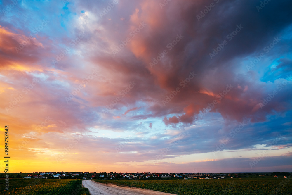 Wall mural Spectacular colorful sunset with cloudy sky in rural area.