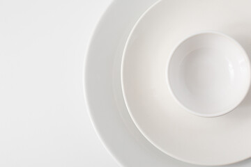Top View of Three White Plates against a White Background