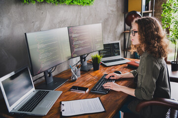 Photo of confident successful young woman hacker software developer sitting armchair comfortable...