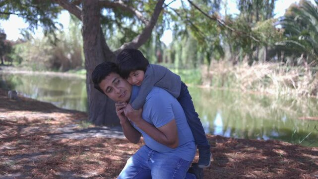 Mexican father playing with his son outdoors, father's day, 4K video