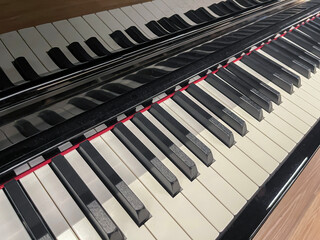 top view of a piano keyboard with its reflection on the lid, full musical octave, musical scale, piano keys, diagonal composition