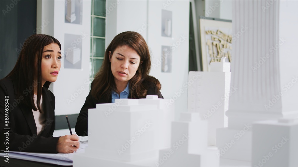 Poster developers team creating floor plan blueprint in agency office, measuring 3d printed building scale 