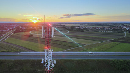 Antenna of communication tower sends signals to self-driving car. Digital wireless connection to a...