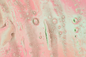Abstract pink background with water oil on the surface