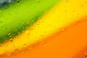 Bright abstract background with multi-colored diagonal stripes with water oil and bubbles