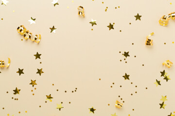 Golden confetti on color background, top view
