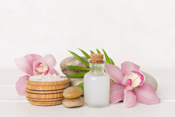 Composition with orchids, spa products on wooden table