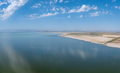 Aerial daytime view of the Salton Sea Coastline with clouds reflecting in the water