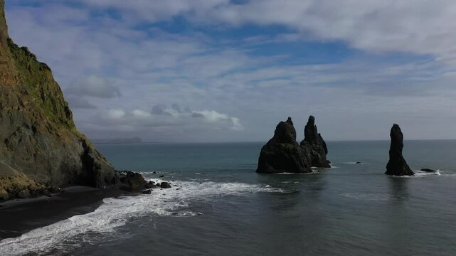 Aerial Drone footage of Reynisfjara Beach and the volcanic black sand and basalt structures in Iceland