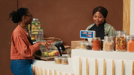 Regular customer buying variety of ripe fruits and veggies, visiting local organic store to restock...
