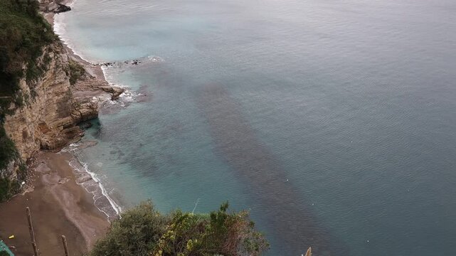 Waves on a rocky beach are seen from above. Ocean coastline. Stop motion moving image clip mp4. Santa Severa Italy