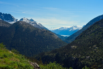 View toward the distant Taiya Inlet at Skagway, Alaska, nestled among the mountains from high up on the White Pass Railroad