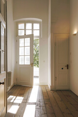Sunlight streaming through an open door into a bright, empty room, suggesting new beginnings and opportunities.