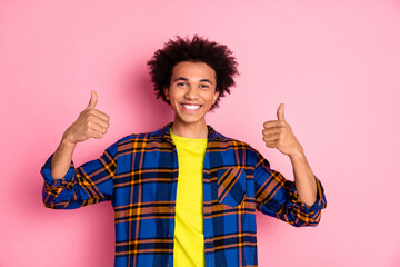 Photo of cheerful nice man wear checkered clothes thumb up isolated on pink color background