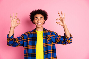 Photo of cheerful glad nice man wear plaid trendy okey sign isolated on pink color background