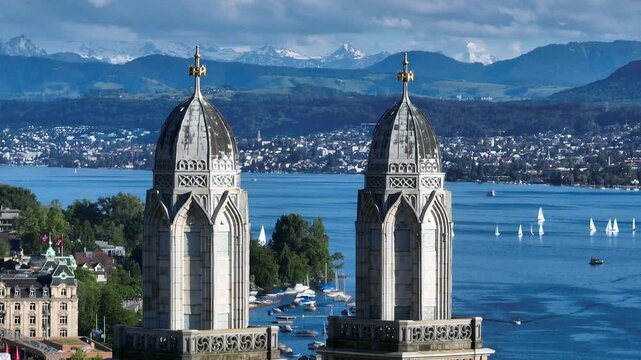 Two towers of Magnificent Grossmunster Cathedral in Zurich close-up, Shot tele lens shot, Alps Mountains on background