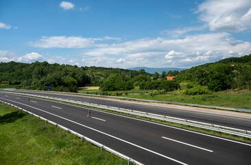 Empty open highway through pastoral landscape