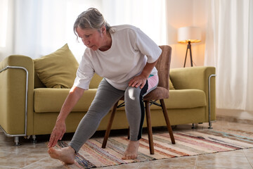Senior caucasian woman doing doing yoga at home on sofa © Viktor Koldunov