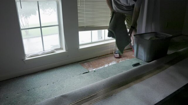 picking up soaking wet carpet padding from hurricane damage
