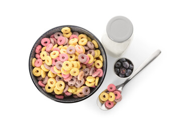 Bowl with colorful sweet cereal rings, bottle of milk and blueberries on white background