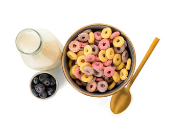 Bowl with colorful sweet cereal rings, bottle of milk and blueberries on white background