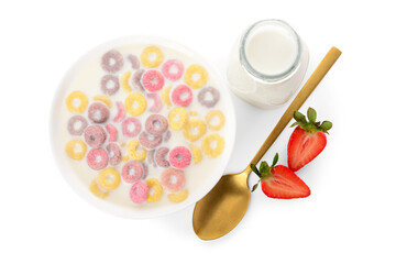 Bowl with colorful sweet cereal rings, bottle of milk and cut strawberry on white background