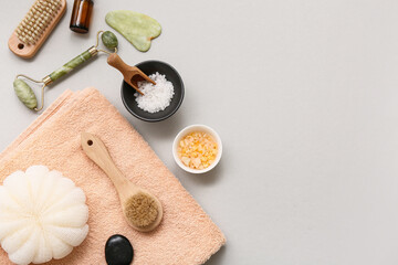 Composition with bath supplies, sea salt, guasha and facial massage tool on white background