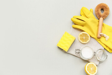 Composition with baking soda, lemons and cleaning supplies on grey background