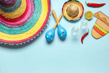 Mexican sombreros with maracas, tequila and chilli on blue background. Cinco de Mayo
