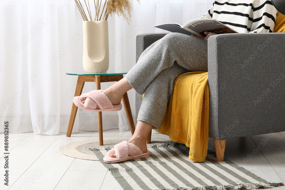 Canvas Prints young woman in pink slippers sitting on armchair in room, closeup