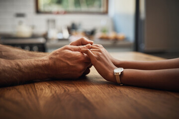 Couple, love and trust with holding hands on table for emotion support, empathy and kindness for...