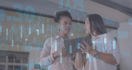 Image of financial data processing over diverse businesswomen in office