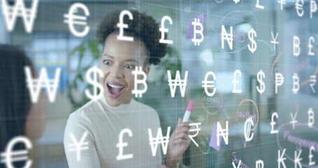 Image of international currency symbols over diverse female colleagues brainstorming at office