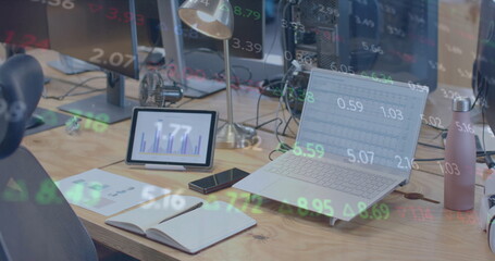 Image of financial data processing over computer on office desk