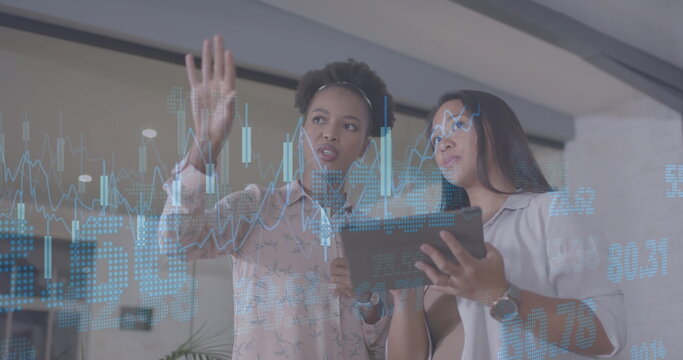 Image of financial data processing over diverse businesswomen in office