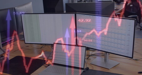 Image of financial data processing over computers on office desk