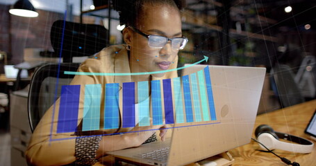 Image of financial data processing over african american businesswoman in office