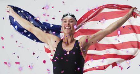 Image of confetti over caucasian female swimmer holding flag of usa