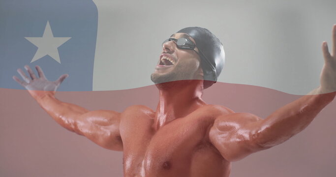 Image of flag of chile over biracial male swimmer
