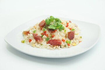 Fried rice dish with sausage, peppers, and cilantro. Perfect for food blogs, restaurant menus, and culinary promotions. Delicious and colorful.