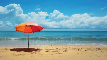 Umbrella on sandy beach with ocean view