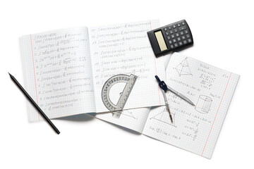 Copybook with handwritten maths formulas, calculator, pencil and ruler isolated on white background