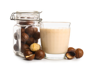 Glass of fresh macadamia milk and jar with nuts on white background