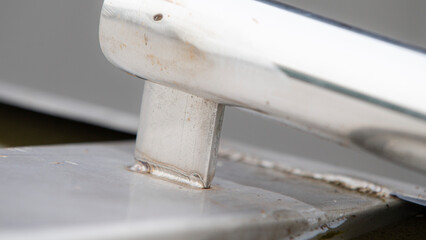 Closeup detail of a white metal with a hole in it