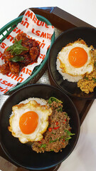 Delicious Thai dishes featuring crispy fried eggs and Stir-fried basil with minced meat on rice.