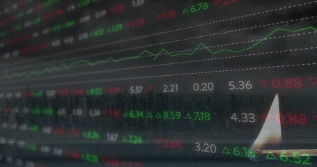 Image of financial data processing over lit match