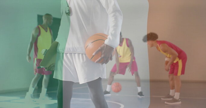 Image of flag of ireland over diverse basketball players on court